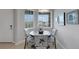 Bright dining area with natural light, featuring stylish chairs and a round wooden table at 12405 Osorio Ct # 202, Sarasota, FL 34238