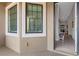 Welcoming entryway featuring large windows, tiled floors, and a charming bench at 12405 Osorio Ct # 202, Sarasota, FL 34238