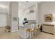 Kitchen with barstool seating and stainless steel appliances adjacent to a hallway with bench at 12405 Osorio Ct # 202, Sarasota, FL 34238