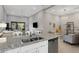 Open-concept kitchen featuring granite countertops and stainless steel appliances flowing into the living space at 12405 Osorio Ct # 202, Sarasota, FL 34238