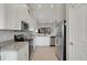 Modern kitchen featuring stainless steel appliances, granite counters, and white cabinets open to the living area at 12405 Osorio Ct # 202, Sarasota, FL 34238