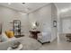 Comfortable living room featuring a stylish rug, cozy seating, and modern shelving at 12405 Osorio Ct # 202, Sarasota, FL 34238