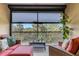 Serene screened patio with comfortable seating overlooking tropical foliage and clear blue skies at 12405 Osorio Ct # 202, Sarasota, FL 34238
