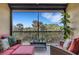 Relaxing screened-in patio with comfortable seating and a view of the lush greenery beyond at 12405 Osorio Ct # 202, Sarasota, FL 34238