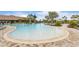 Expansive community pool with sunning deck, lounge chairs and splash fountains at 12405 Osorio Ct # 202, Sarasota, FL 34238