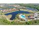 Aerial view showcasing the community's lake, swimming pool, clubhouse, and meticulously landscaped surroundings at 14404 Stirling Dr, Lakewood Ranch, FL 34202