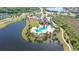 Aerial view of the community pool, clubhouse, and surrounding lush landscaping and lakes at 14404 Stirling Dr, Lakewood Ranch, FL 34202