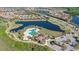 An aerial view of the community, highlighting the community pool and clubhouse, surrounded by lush landscaping and lakes at 14404 Stirling Dr, Lakewood Ranch, FL 34202