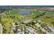 Aerial view of a golf course community, complete with a golf course, clubhouse, and ample parking at 14404 Stirling Dr, Lakewood Ranch, FL 34202