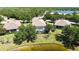 Aerial view showing a home next to a lake and its backyard with screened pool at 14404 Stirling Dr, Lakewood Ranch, FL 34202