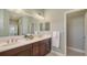 Bright bathroom features double sinks, a large mirror, and neutral colored paint at 14404 Stirling Dr, Lakewood Ranch, FL 34202