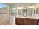 Bathroom featuring a double vanity, a tiled shower, and a large mirror at 14404 Stirling Dr, Lakewood Ranch, FL 34202