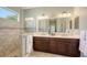 Bathroom featuring a double vanity, a tiled shower, and a large mirror at 14404 Stirling Dr, Lakewood Ranch, FL 34202