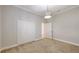 Bedroom has a double closet, woven pendant light and carpet flooring at 14404 Stirling Dr, Lakewood Ranch, FL 34202