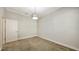 This carpeted bedroom features a woven light fixture and a door at 14404 Stirling Dr, Lakewood Ranch, FL 34202