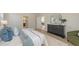 Spacious bedroom with wood floors features neutral walls, and a comfortable area for relaxing at 14404 Stirling Dr, Lakewood Ranch, FL 34202