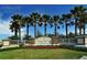 Inviting community entrance sign with lush landscaping, and rows of swaying palm trees at 14404 Stirling Dr, Lakewood Ranch, FL 34202