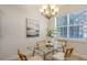 Bright dining area with glass table, chandelier, and view of lake at 14404 Stirling Dr, Lakewood Ranch, FL 34202