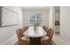 Bright dining area with a light wood table, seating for eight, and natural light from a large window at 14404 Stirling Dr, Lakewood Ranch, FL 34202