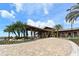 Stately building featuring a grand entrance, lush landscaping and manicured surroundings with palm trees at 14404 Stirling Dr, Lakewood Ranch, FL 34202