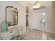 Spacious foyer with decorative console table, light fixture, and views into the home at 14404 Stirling Dr, Lakewood Ranch, FL 34202