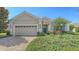 Lovely single-Gathering home featuring a well-manicured lawn, charming blue door, and two car garage at 14404 Stirling Dr, Lakewood Ranch, FL 34202