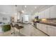 Modern kitchen with bar and stainless appliances is part of an open floorplan at 14404 Stirling Dr, Lakewood Ranch, FL 34202