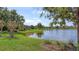 Scenic lake view surrounded by green lawns, showcasing the tranquil neighborhood at 14404 Stirling Dr, Lakewood Ranch, FL 34202