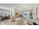 Spacious living room featuring neutral tones, plush seating, and views of the pool and water at 14404 Stirling Dr, Lakewood Ranch, FL 34202