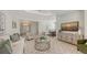 Elegant living room featuring comfortable seating, stylish decor, and an open view into the dining area at 14404 Stirling Dr, Lakewood Ranch, FL 34202