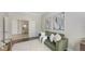 Stylish living space featuring a cozy green sofa, decorative art, and an open floor plan at 14404 Stirling Dr, Lakewood Ranch, FL 34202