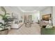 Bright living room features tray ceilings, modern furniture, an elegant area rug, and an open floor plan at 14404 Stirling Dr, Lakewood Ranch, FL 34202