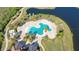 Aerial view of a unique swimming pool surrounded by palm trees and manicured landscaping at 14404 Stirling Dr, Lakewood Ranch, FL 34202