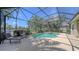 A screened-in pool and patio area with lounge chairs offers a relaxing outdoor space at 14404 Stirling Dr, Lakewood Ranch, FL 34202