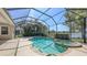 Screened-in pool and hot tub overlooking a serene lake at 14404 Stirling Dr, Lakewood Ranch, FL 34202