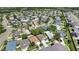 A picturesque aerial shot of a residential area with neat homes, mature trees, and curving roads at 16620 Fairbolt Way, Odessa, FL 33556