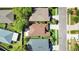 An aerial view of houses showing their roof, lawn and landscaping, as well as the street, sidewalks, and neighboring homes at 16620 Fairbolt Way, Odessa, FL 33556