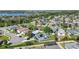 An eye-level aerial view showcases cozy homes and serene streets in this quiet neighborhood near a tranquil lake at 16620 Fairbolt Way, Odessa, FL 33556