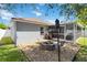 Charming backyard with a fire pit, seating, and a screened-in porch at 16620 Fairbolt Way, Odessa, FL 33556
