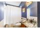 Bathroom featuring blue walls, vanity with marble countertop, and shower/tub combination with white curtain at 16620 Fairbolt Way, Odessa, FL 33556