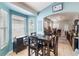 Cozy breakfast nook with bright windows, a dark-toned table set, and an adjacent bar area at 16620 Fairbolt Way, Odessa, FL 33556
