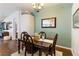Formal dining room featuring wood floors, a decorative chandelier, and a unique archway entrance at 16620 Fairbolt Way, Odessa, FL 33556