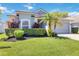 Inviting single-story home featuring vibrant landscaping, mature trees, and a gray two-car garage at 16620 Fairbolt Way, Odessa, FL 33556