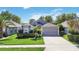 Well-maintained single-Gathering home with landscaped front yard, a two-car garage, and neutral-colored exterior at 16620 Fairbolt Way, Odessa, FL 33556