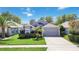 Well-maintained single-Gathering home with landscaped front yard, a two-car garage, and neutral-colored exterior at 16620 Fairbolt Way, Odessa, FL 33556