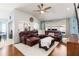 Spacious living room with a large leather sectional, vaulted ceilings, and an airy feel at 16620 Fairbolt Way, Odessa, FL 33556