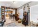 Open-concept living room flowing into the kitchen, featuring a unique bar setup and ample natural light at 16620 Fairbolt Way, Odessa, FL 33556