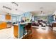 Open-concept living space featuring a breakfast bar, living room, and dining area at 16620 Fairbolt Way, Odessa, FL 33556