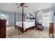 Spacious main bedroom with a four-poster bed, neutral paint, and carpeted floors at 16620 Fairbolt Way, Odessa, FL 33556
