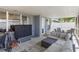 Enclosed patio with stone floors, stylish outdoor furniture, and view of lush backyard provides a relaxing space at 16620 Fairbolt Way, Odessa, FL 33556